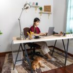 woman working at a desk on a laptop at home