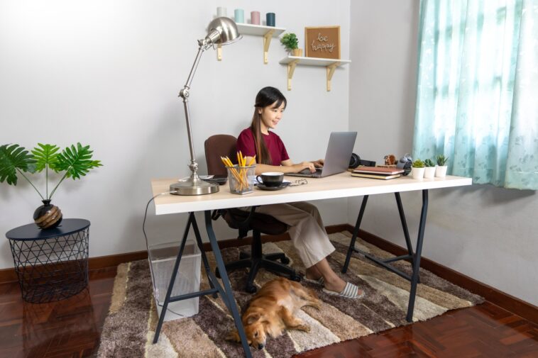 woman working at a desk on a laptop at home