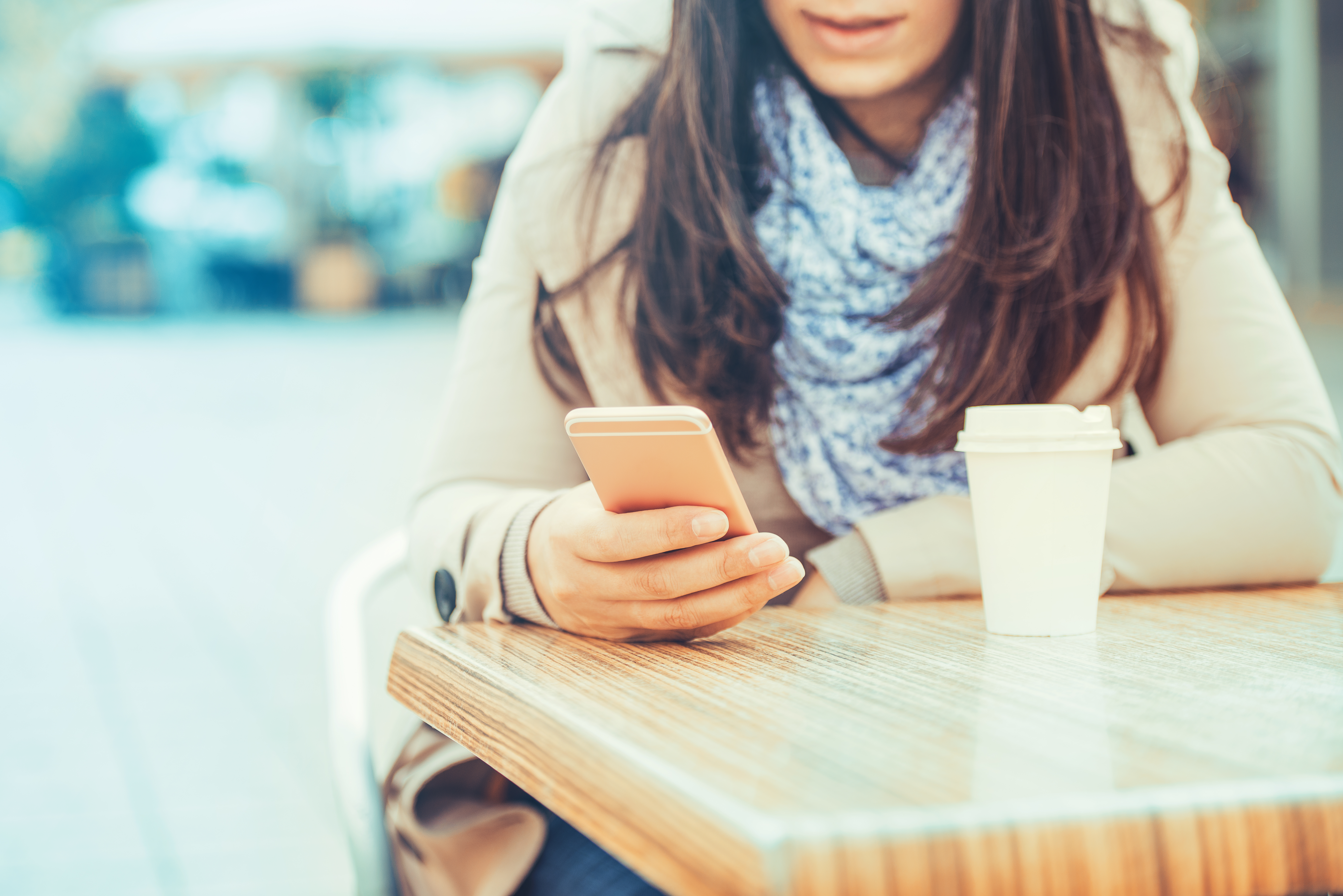 woman using a smartphone in a coffee shop