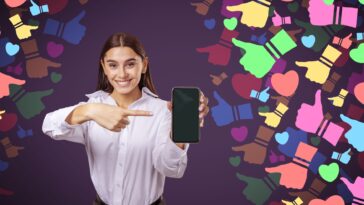 woman pointing at a smartphone with colorful social media icons around her