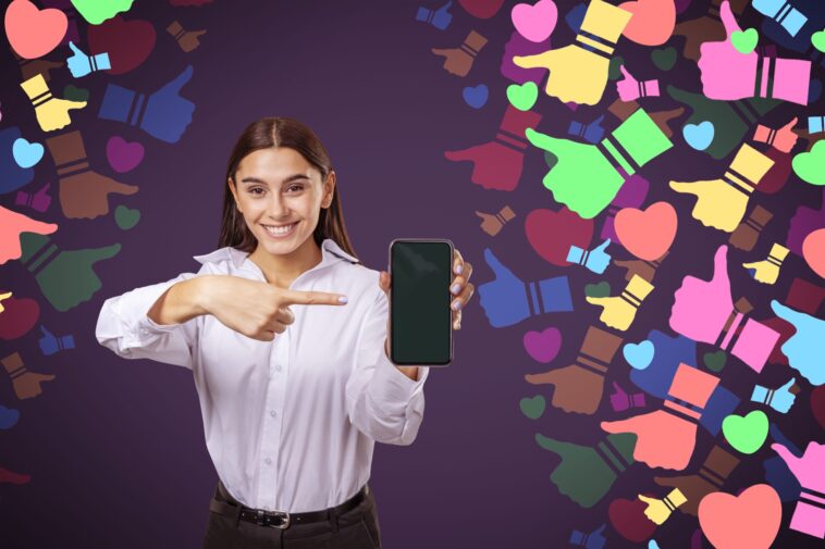 woman pointing at a smartphone with colorful social media icons around her