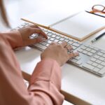 close-up of women hands typing on a keyboard