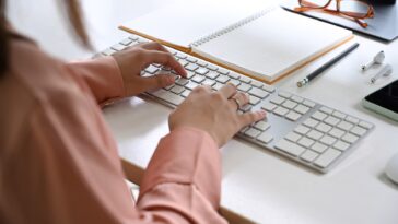 close-up of women hands typing on a keyboard