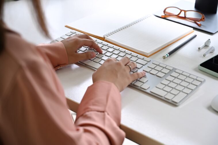 close-up of women hands typing on a keyboard