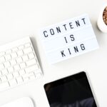 content is king sign next to a computer keyboard