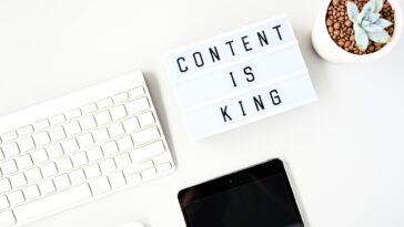 content is king sign next to a computer keyboard