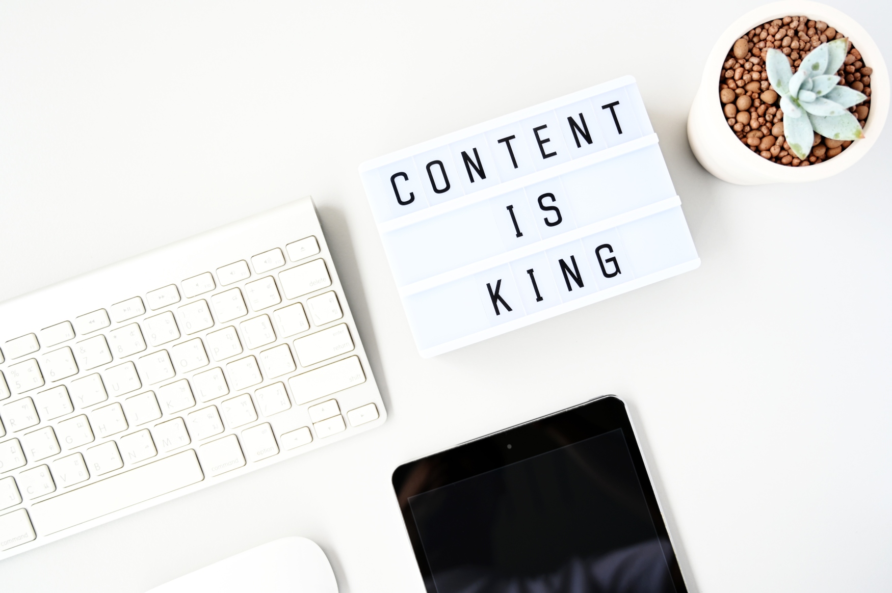 content is king sign next to a computer keyboard