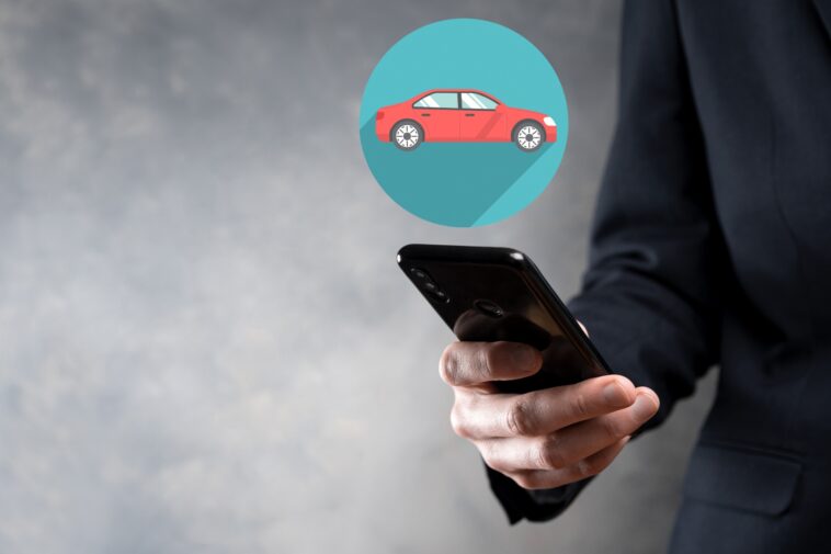 man holding a smartphone with a 3d car icon