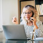 woman working from home talking on a phone