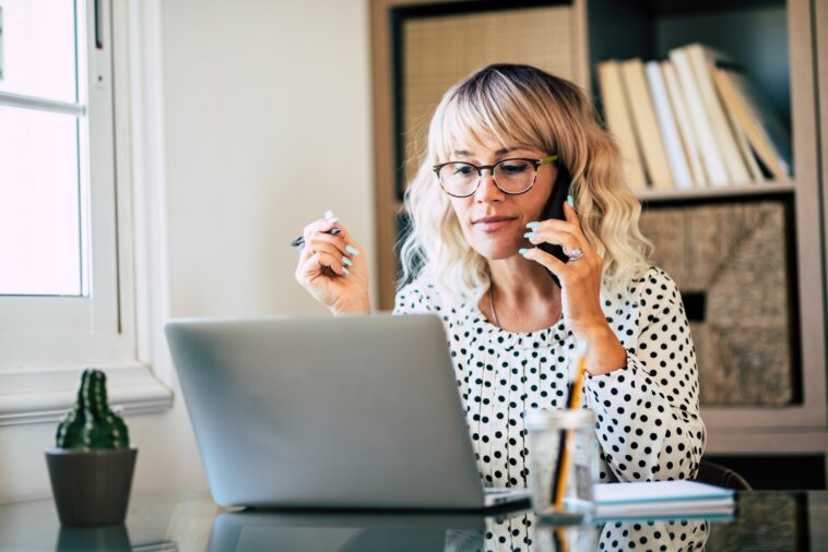 woman working from home talking on a phone