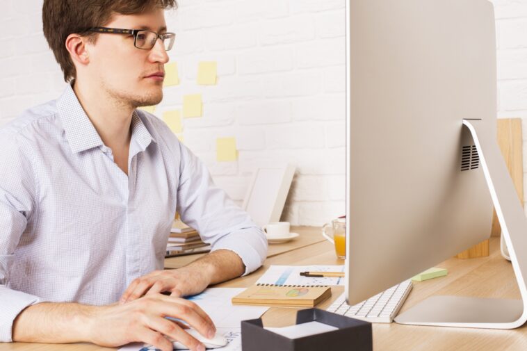 man working on a computer from home