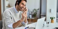 man talking with a headset at home