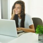 woman sitting at a desk using a laptop