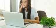 woman sitting at a desk using a laptop