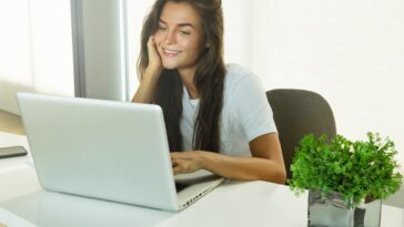 woman sitting at a desk using a laptop