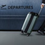 businessman with luggage walking inside an airport terminal