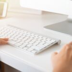 closeup of hands using a computer keyboard and mouse