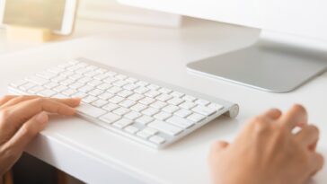 closeup of hands using a computer keyboard and mouse