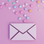 digital envelope with colorful 3d hearts on a pink background