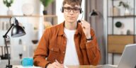 man using a headset and a laptop working from home