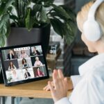 woman with headset on a video call with multiple people