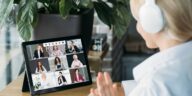 woman with headset on a video call with multiple people