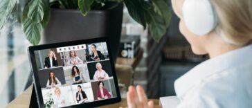 woman with headset on a video call with multiple people