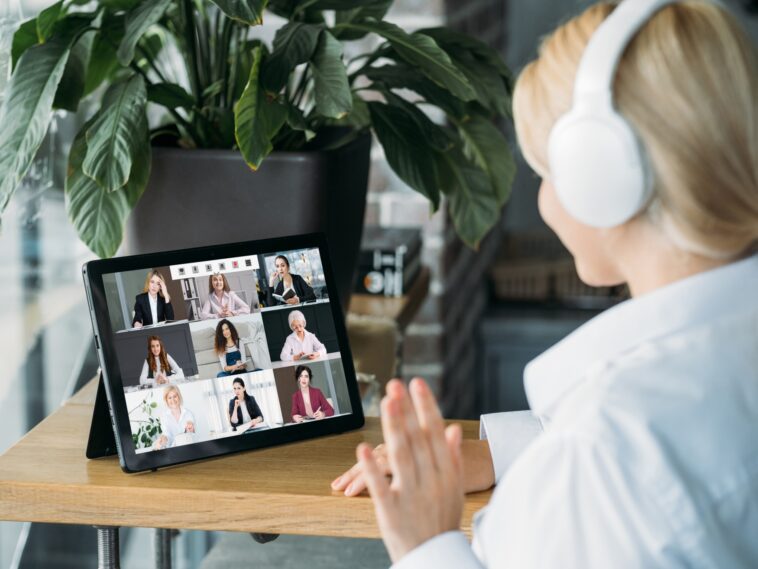 woman with headset on a video call with multiple people