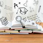 books on a wooden table with 3D education icons above them