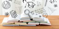 books on a wooden table with 3D education icons above them