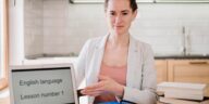 woman next to a laptop screen that says English language