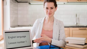 woman next to a laptop screen that says English language
