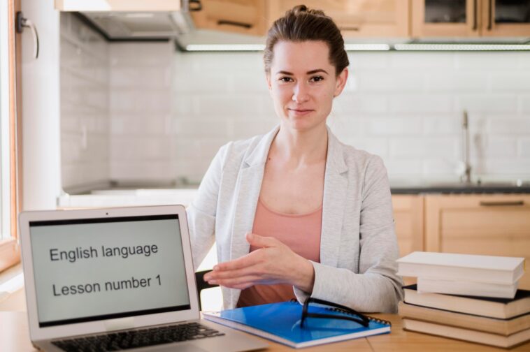 woman next to a laptop screen that says English language