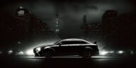 black Lexus with a dark city background