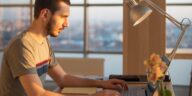 man working on a laptop at an office desk