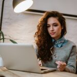 woman working on a laptop in a bright modern room