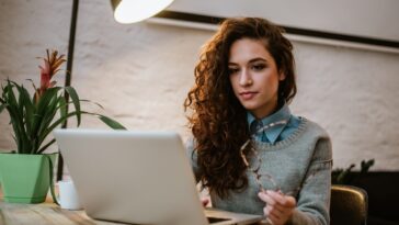 woman working on a laptop in a bright modern room