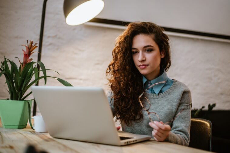 woman working on a laptop in a bright modern room