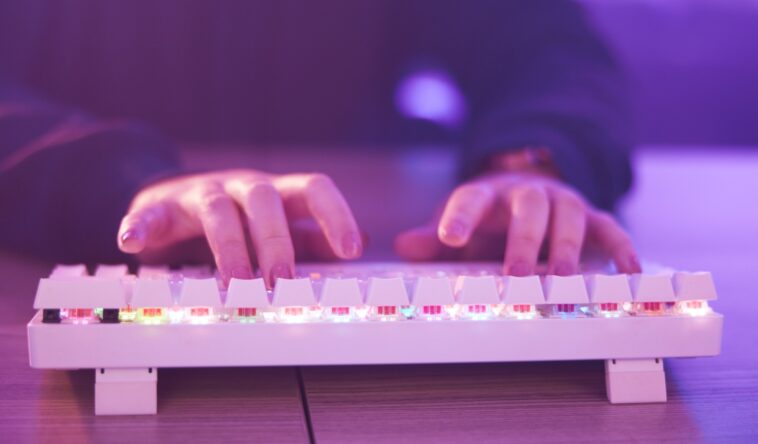 hands typing on a gaming keyboard