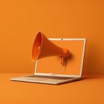 orange megaphone coming out of a laptop screen