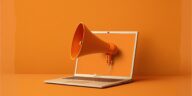 orange megaphone coming out of a laptop screen