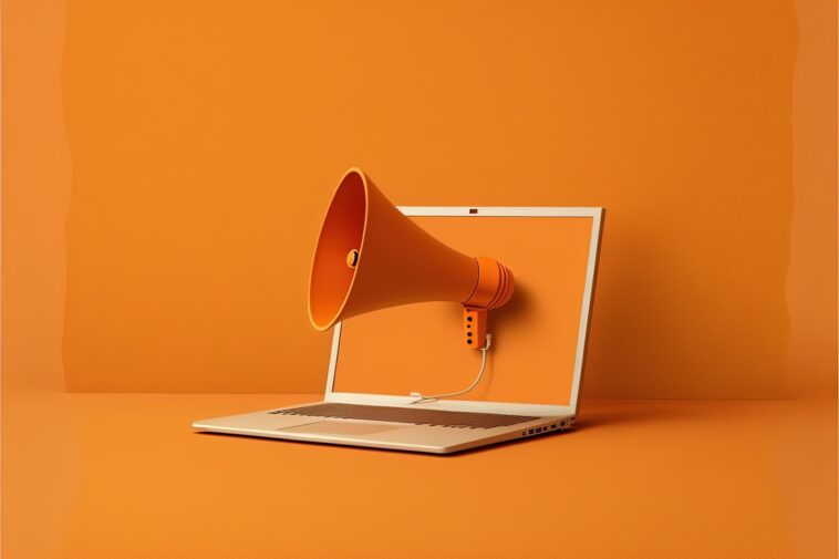 orange megaphone coming out of a laptop screen