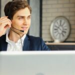 man with headset working remotely