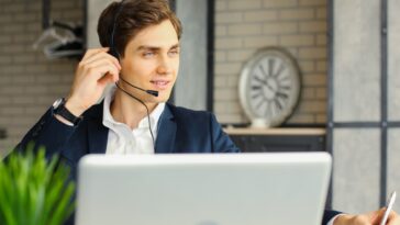 man with headset working remotely