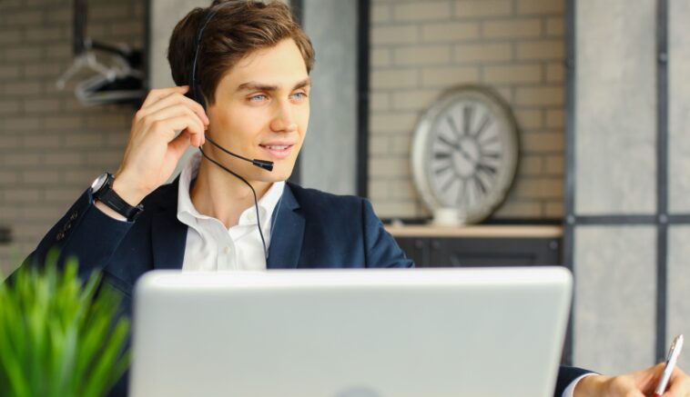 man with headset working remotely