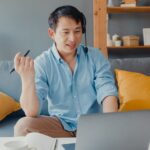 man with headset on a video call working from home