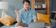 man with headset on a video call working from home