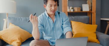 man with headset on a video call working from home