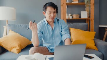 man with headset on a video call working from home