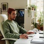 man working on a computer from home